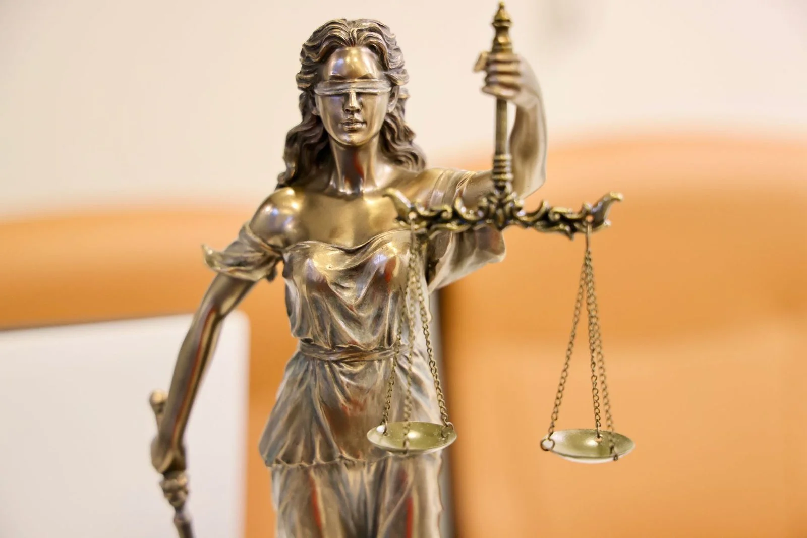 Statue of Lady Justice, blindfolded and holding scales, symbolizing fairness and impartiality.