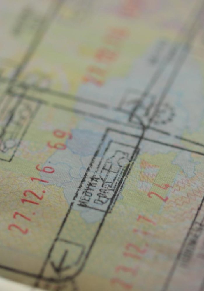 close-up-part-foreign-passport-with-foreign-visas-border-stamps-permits-enter-countries-concept-traveling-around-world